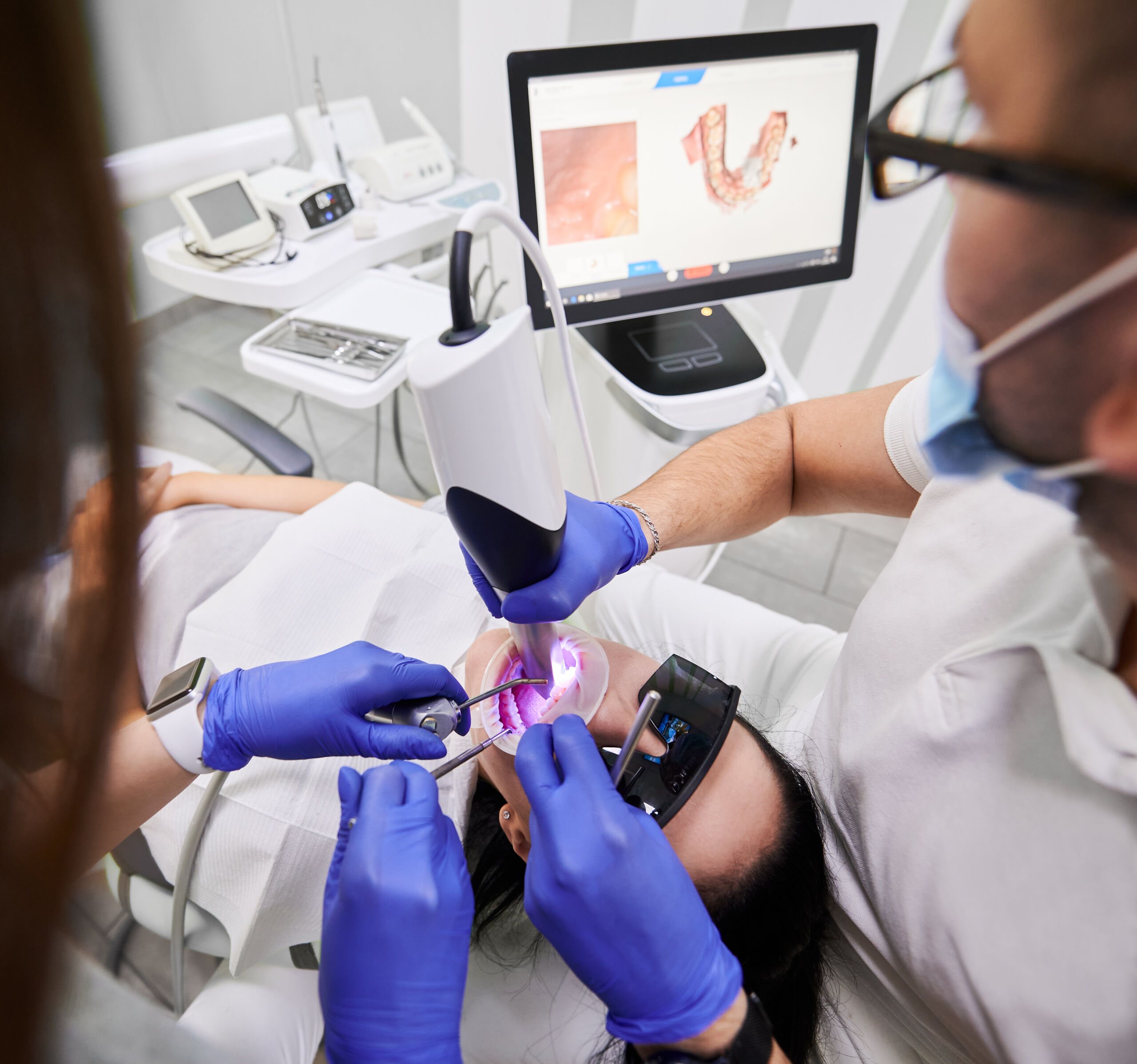 Dentist and assistants performing root canal Greensboro, NC - MANGO DENTAL Dentist and assistants performing root canal Greensboro, NC